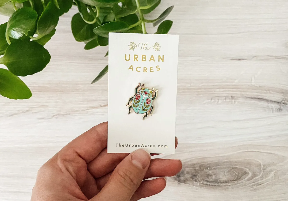 Beetle enamel pin on a branded card